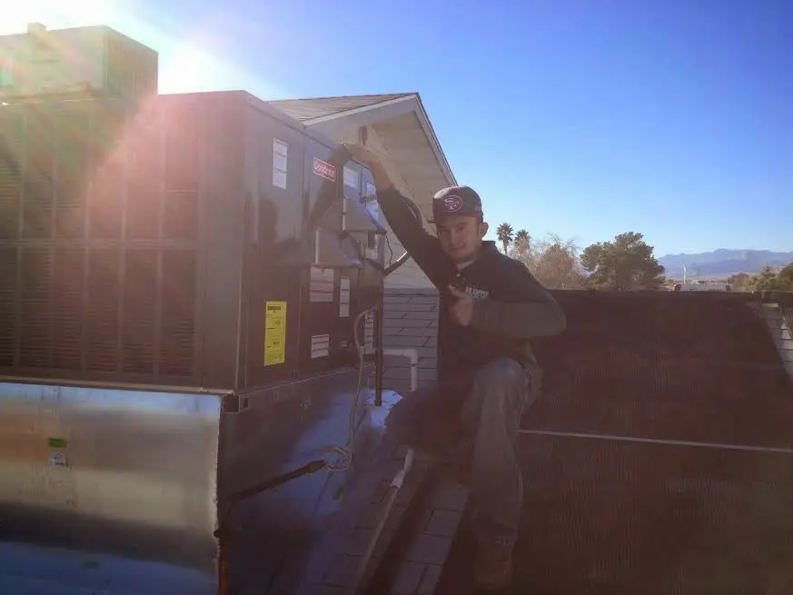 HVAC technician performing AC Tune-Up on a rooftop unit in Hidden Valley Lake